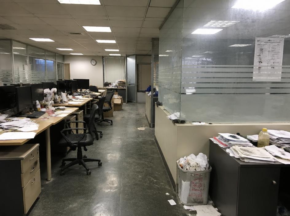 Cluttered office workspace before commercial cleaning